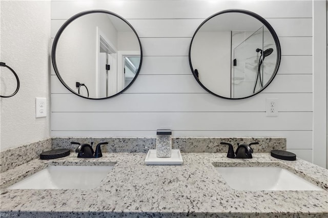 bathroom featuring vanity and wood walls