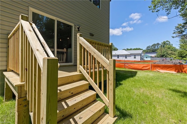 wooden terrace featuring a lawn