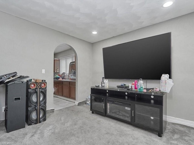 carpeted living room featuring sink