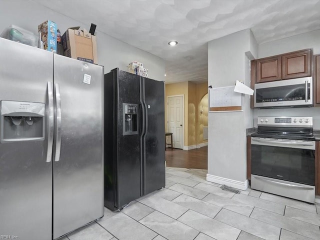 kitchen with stainless steel appliances and light hardwood / wood-style flooring