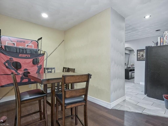 dining space featuring wood-type flooring