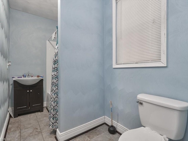 bathroom with tile patterned flooring, toilet, and vanity