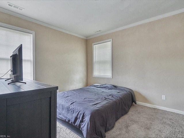 carpeted bedroom with ornamental molding