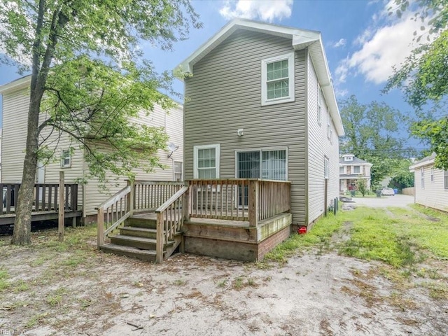 back of house featuring a deck