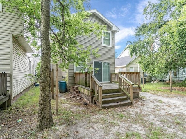 back of house featuring a wooden deck