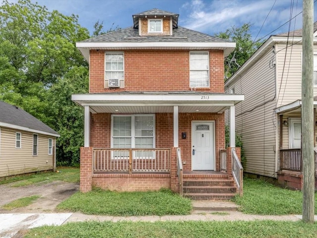 view of front of home with cooling unit and a porch