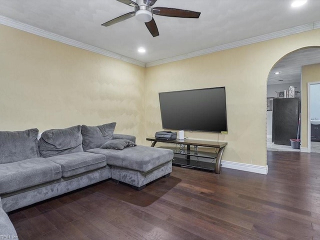 living room with ceiling fan, crown molding, and dark hardwood / wood-style flooring