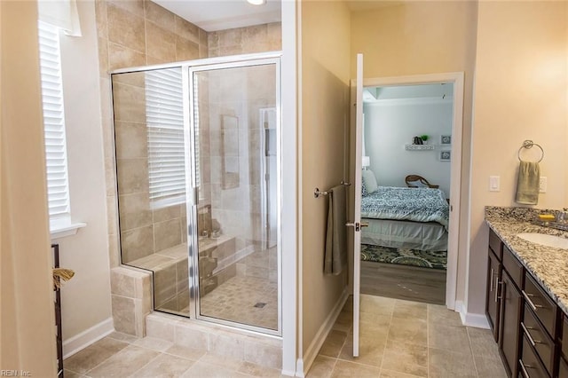 bathroom with tile patterned floors, an enclosed shower, and vanity