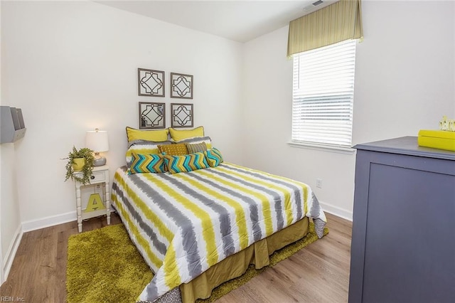 bedroom with wood-type flooring