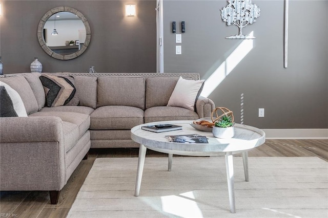 living room with an inviting chandelier and wood-type flooring