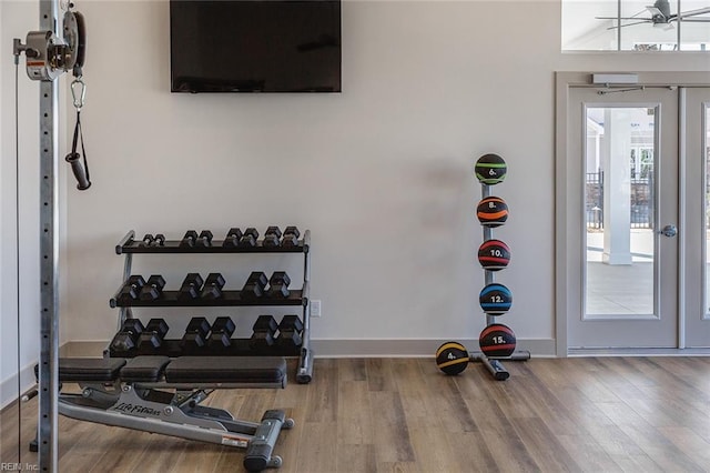 exercise room with wood-type flooring