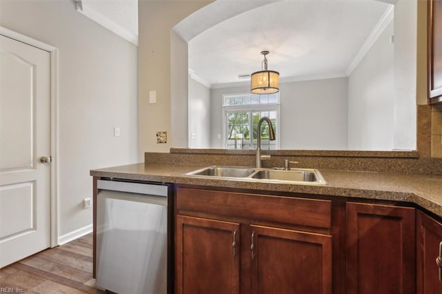 kitchen with sink, decorative light fixtures, crown molding, dark wood-type flooring, and stainless steel dishwasher