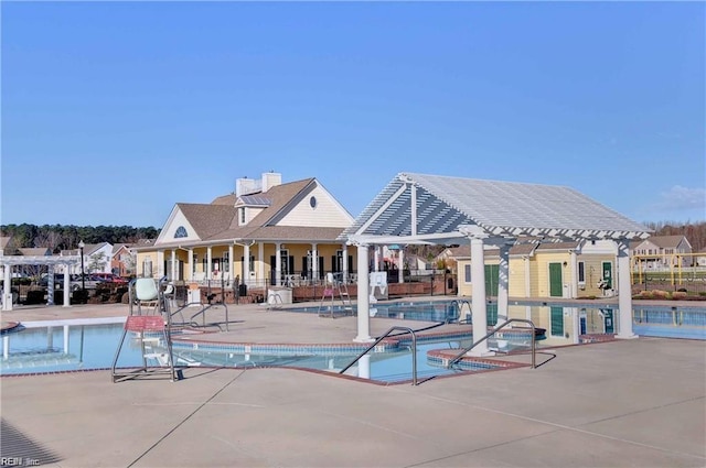 view of pool with a pergola and a patio area