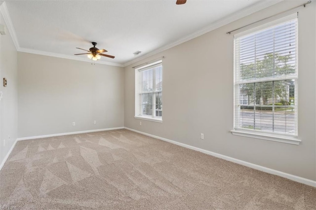 unfurnished room with ornamental molding, light colored carpet, and ceiling fan