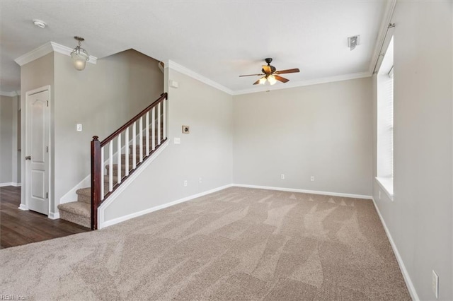 empty room featuring ornamental molding, dark carpet, and ceiling fan