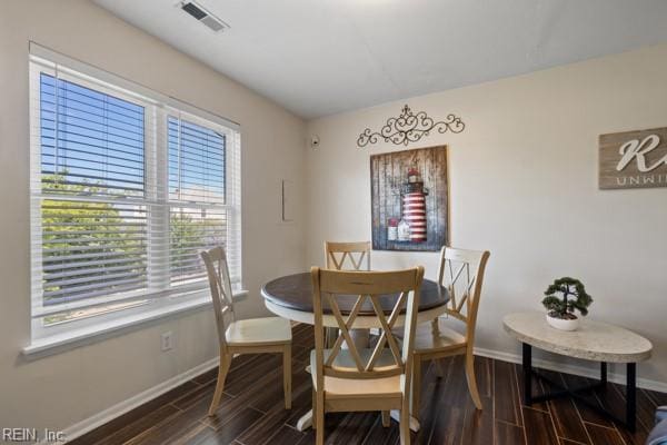 dining room with dark hardwood / wood-style flooring