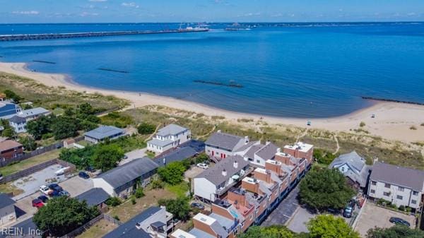 birds eye view of property featuring a beach view and a water view