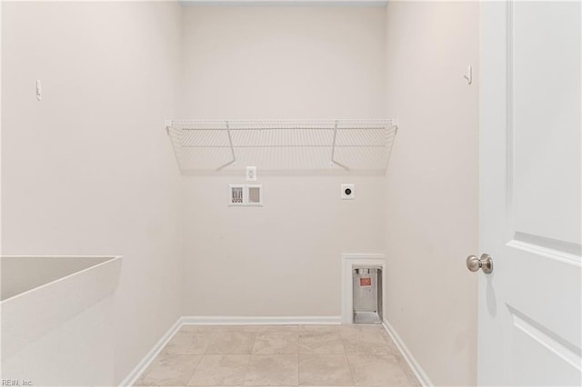 clothes washing area featuring light tile patterned floors, hookup for a washing machine, and hookup for an electric dryer