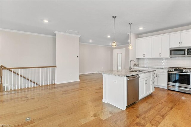 unfurnished living room with ornamental molding and light wood-type flooring