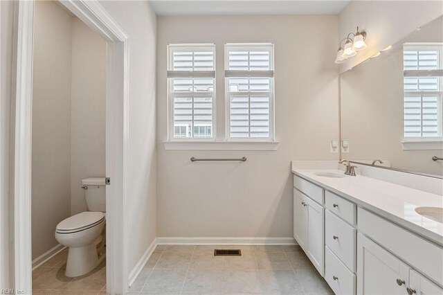 bathroom featuring tile patterned flooring, vanity, and walk in shower