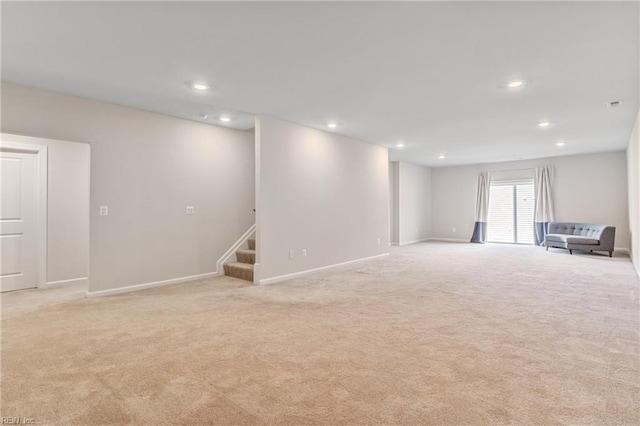 basement featuring light carpet