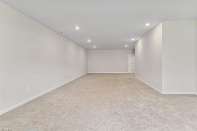 unfurnished room with light colored carpet