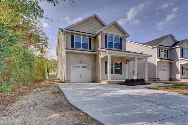 view of front of property featuring concrete driveway and a garage