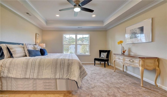 bedroom featuring a raised ceiling, ceiling fan, light carpet, and ornamental molding