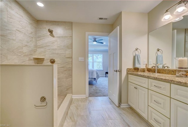 full bathroom with visible vents, a walk in shower, ceiling fan, vanity, and ensuite bath