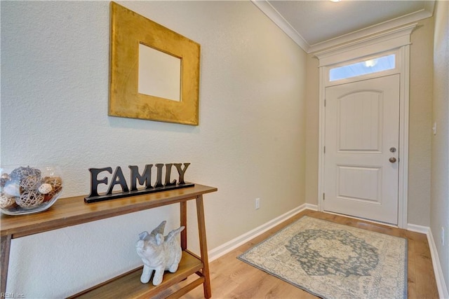 entryway with crown molding, baseboards, and wood finished floors