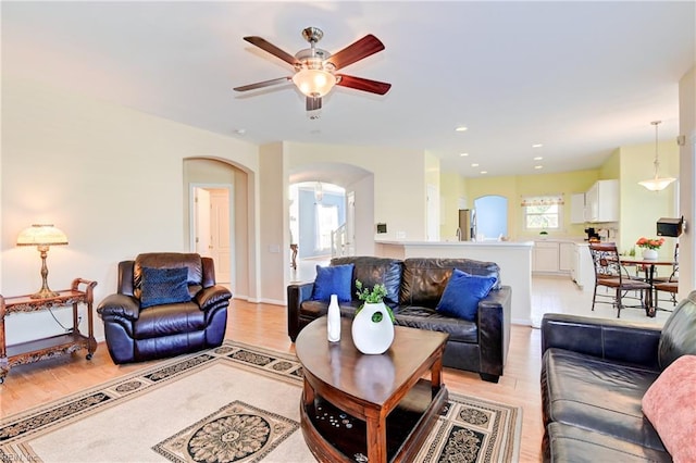 living room featuring ceiling fan and light wood-type flooring