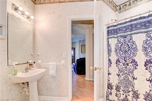 bathroom with hardwood / wood-style flooring and a shower with shower curtain