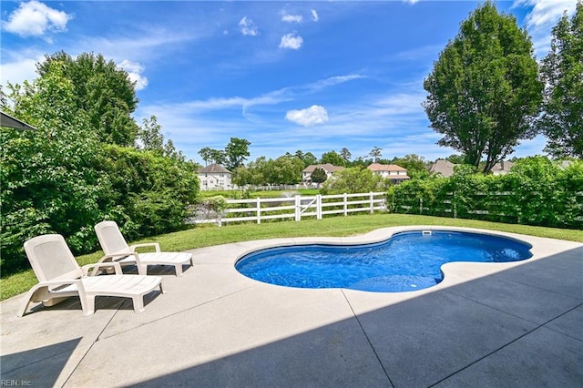 view of pool with a lawn and a patio