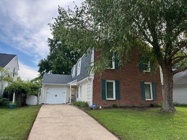 view of front of home with a front lawn and a garage