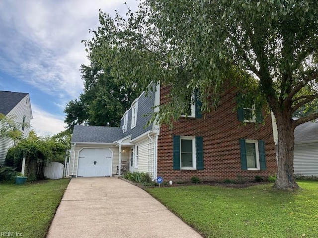 view of front of house with a garage, driveway, brick siding, and a front yard