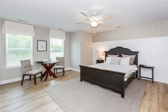 bedroom with light hardwood / wood-style floors and ceiling fan