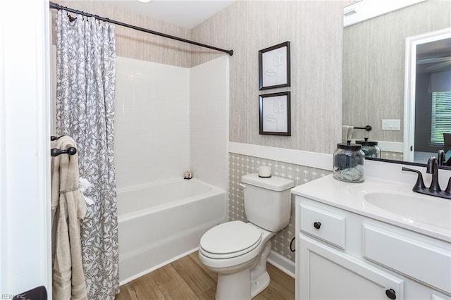 full bathroom with toilet, vanity, wood-type flooring, and shower / tub combo