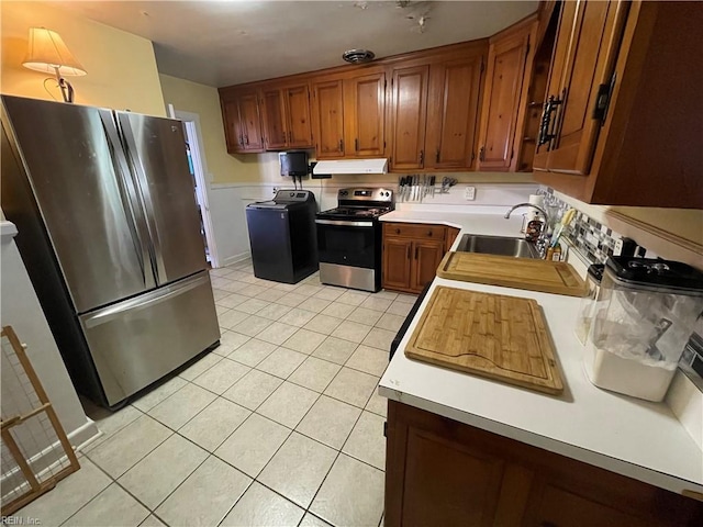 kitchen featuring sink, light tile patterned floors, and appliances with stainless steel finishes