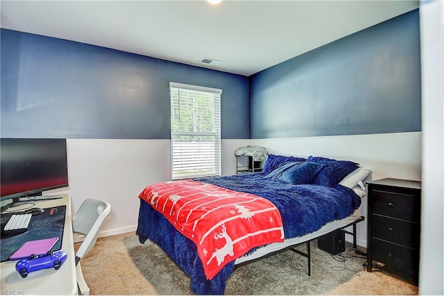 bedroom featuring light colored carpet