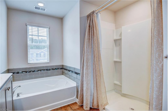 bathroom with hardwood / wood-style floors, plus walk in shower, and vanity