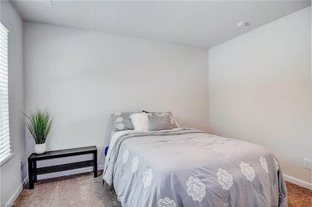 carpeted bedroom featuring baseboards