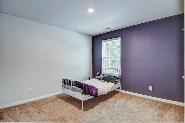 bedroom featuring carpet floors, visible vents, and baseboards