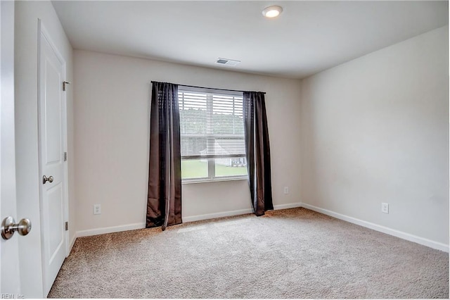 empty room featuring light carpet