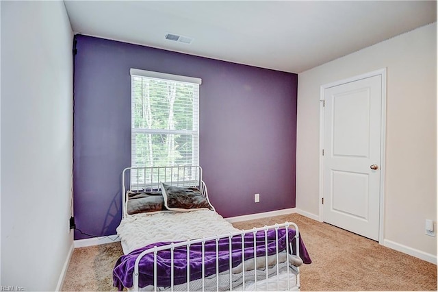 carpeted bedroom with baseboards and visible vents