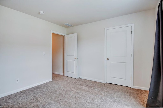 unfurnished bedroom featuring light carpet