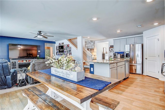 dining space featuring ceiling fan and light hardwood / wood-style floors