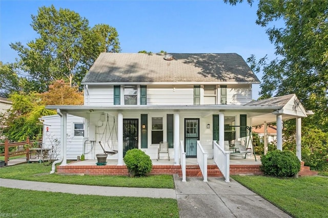 view of front of house with covered porch and a front yard