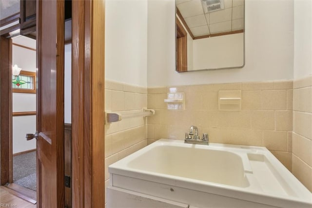 bathroom featuring tile walls and hardwood / wood-style floors