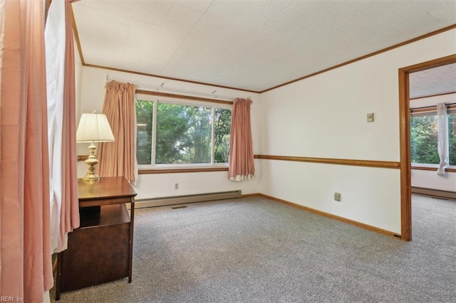 carpeted empty room featuring a wealth of natural light, ornamental molding, and a baseboard heating unit