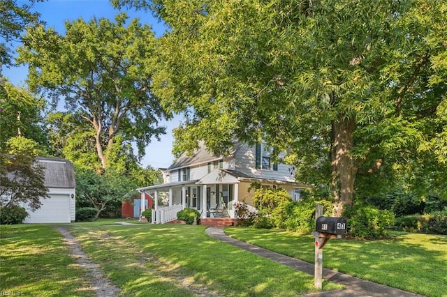 view of front of house featuring a front lawn, an outdoor structure, and a garage